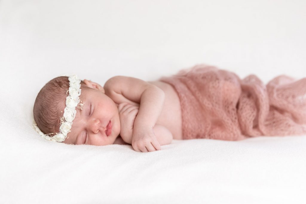 Closeup of an Newborn with a flower-bead